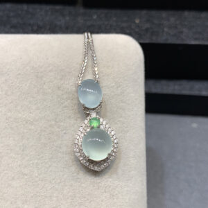 Elegant 18K gold jade necklaces with ice-clear oval pendants showcasing natural jade stones