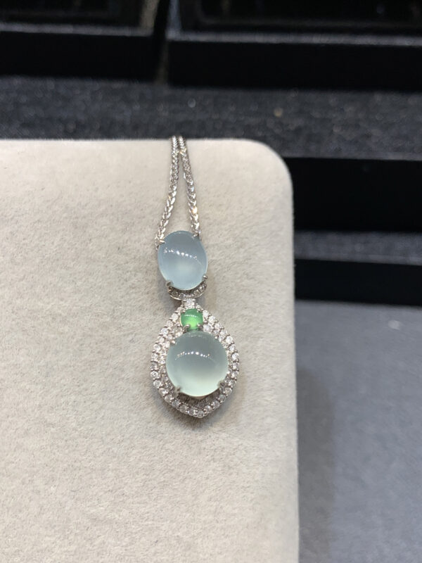 Elegant 18K gold jade necklaces with ice-clear oval pendants showcasing natural jade stones