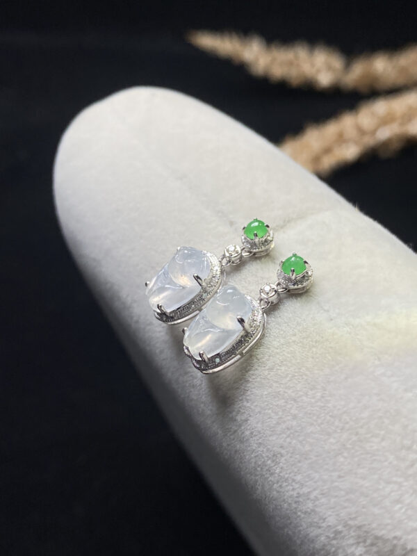 Front view of 18K high ice jade stone earrings featuring delicate cicada design and translucent jade