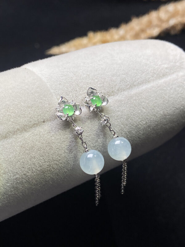 Front view of 18K high ice jade trau earrings showing radiant translucent jade beads