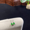 Front view of 18K imperial jade earrings featuring carved gourd-shaped jade stones