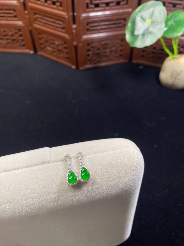 Front view of 18K imperial jade earrings featuring carved gourd-shaped jade stones