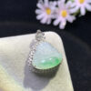 Side profile of 18K gold carved jadeite pendant showing thickness and craftsmanship