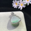 Back view of carved jadeite pendant showing smooth jade surface and gold clasp