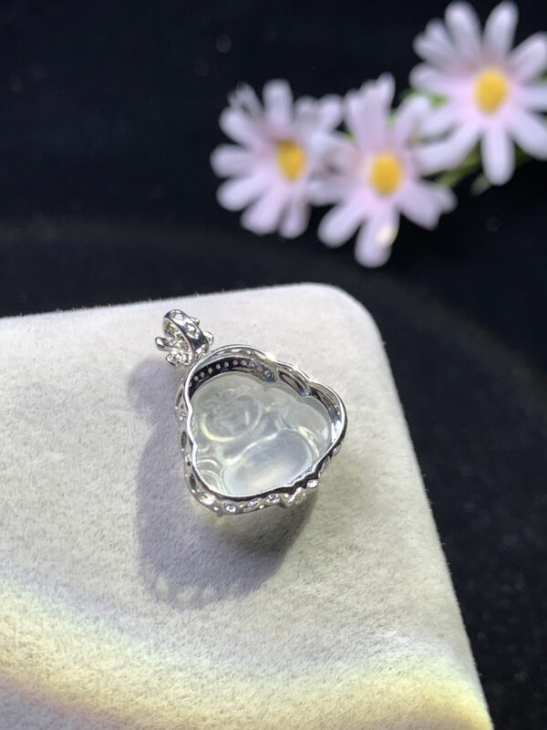 Side profile of 18K gold pendant with white jade Buddha showing depth and thickness