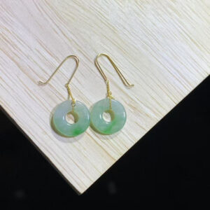Front view of antique jade earrings featuring sweet green donut-shaped jade