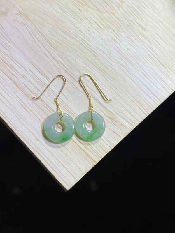 Front view of antique jade earrings featuring sweet green donut-shaped jade