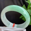 Left angle of apple green authentic jade bangle