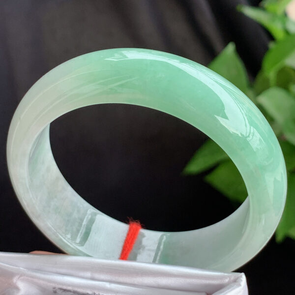 Left angle of apple green authentic jade bangle