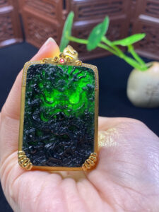 Side profile of black jade dragon pendant in 18K gold