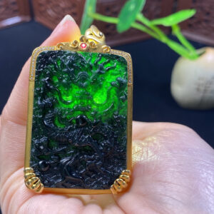 Side profile of black jade dragon pendant in 18K gold