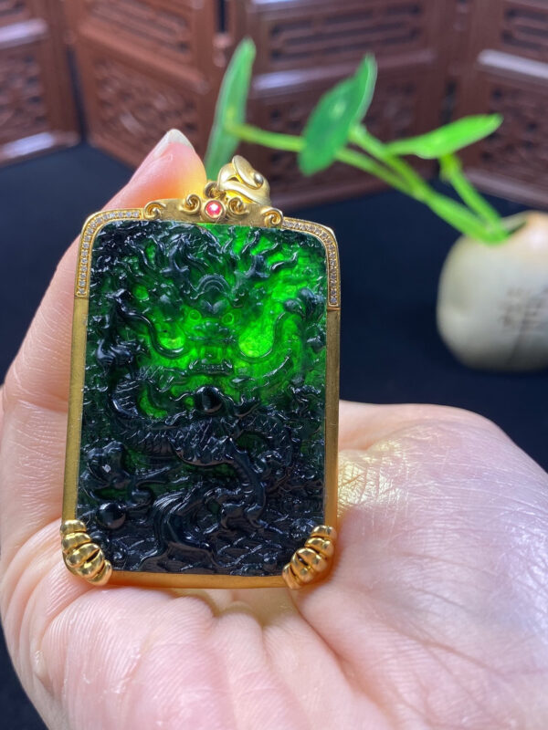 Side profile of black jade dragon pendant in 18K gold