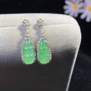 front view of earrings with jade in icy green gourd design