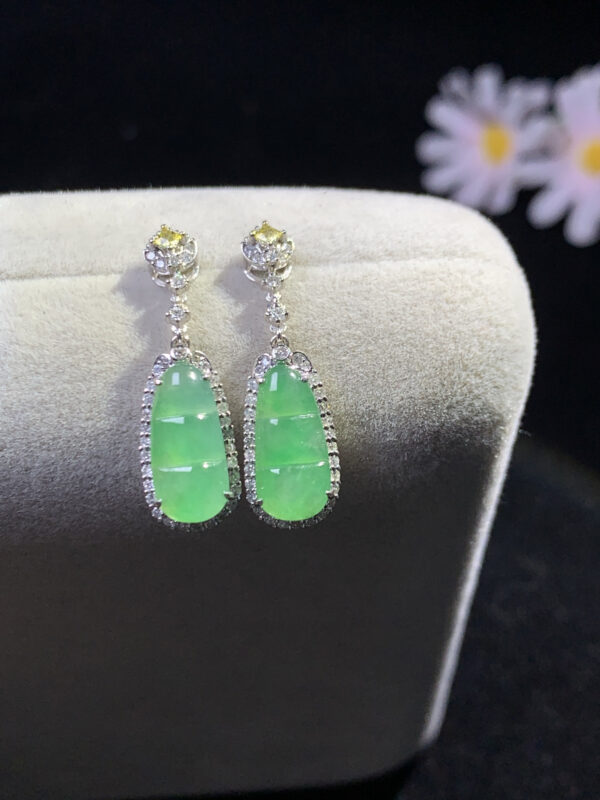 front view of earrings with jade in icy green gourd design