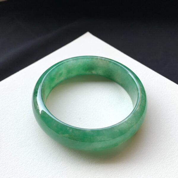 Front view of full-green icy green jade bracelets measuring 57.6mm