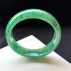 Full-green icy green jade bracelets photographed under natural light