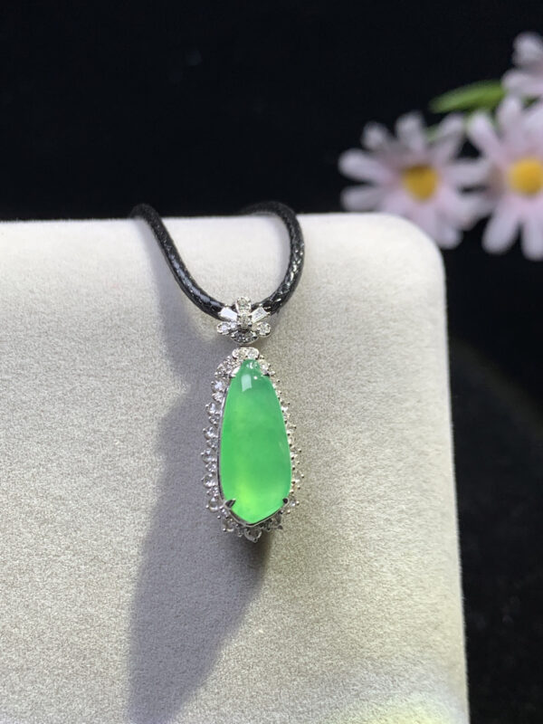 Front view of gourd-shaped pendant in green jade colour with 18K gold setting