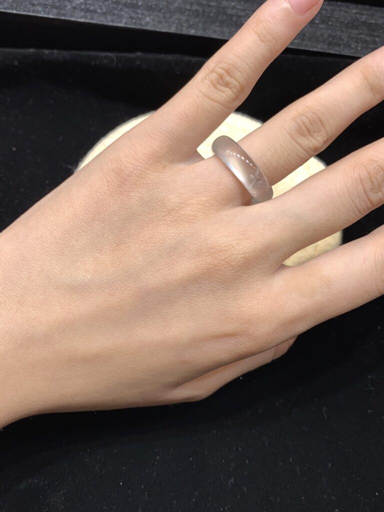Cleaning a jade ring with soft cloth and warm water