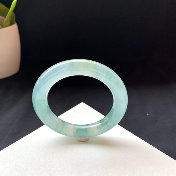 Right angle view of 56.7mm jade bangle bracelet with translucent finish
