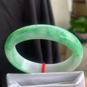 Collection of icy green oval jade bangles with princess-style design