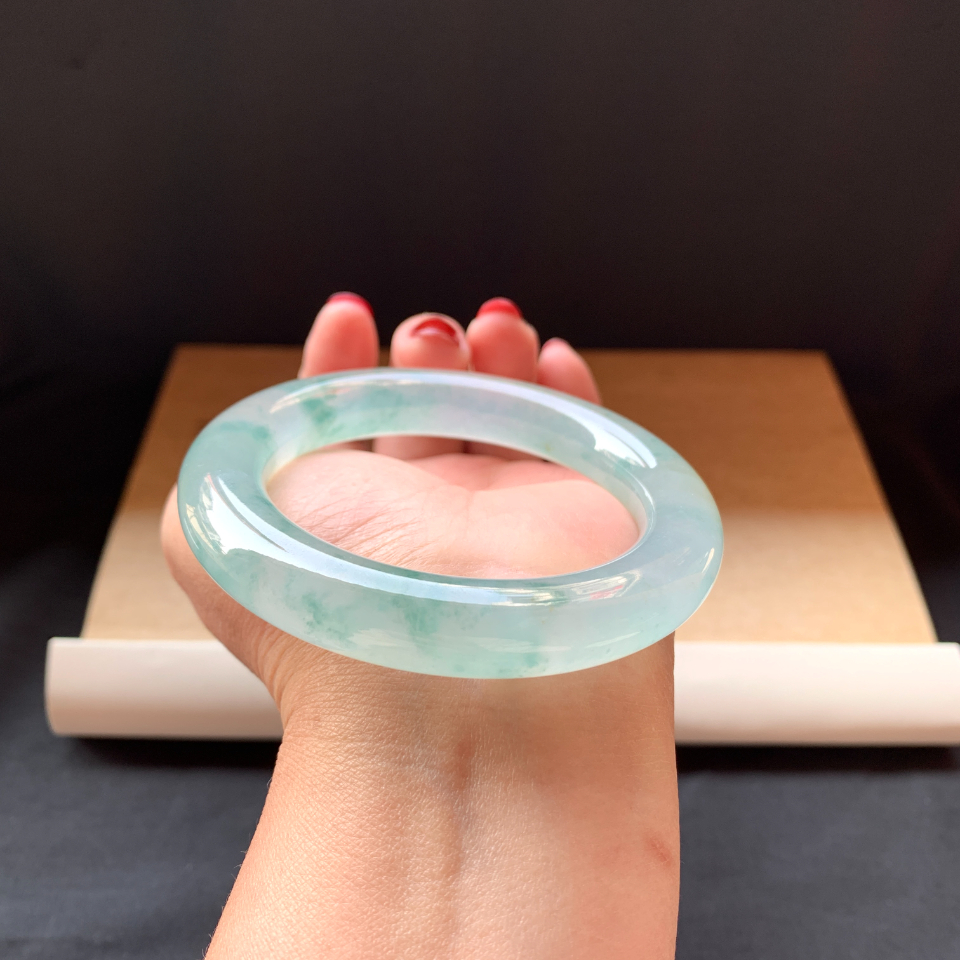 Close-up of jade bracelet texture showing translucency and color variations