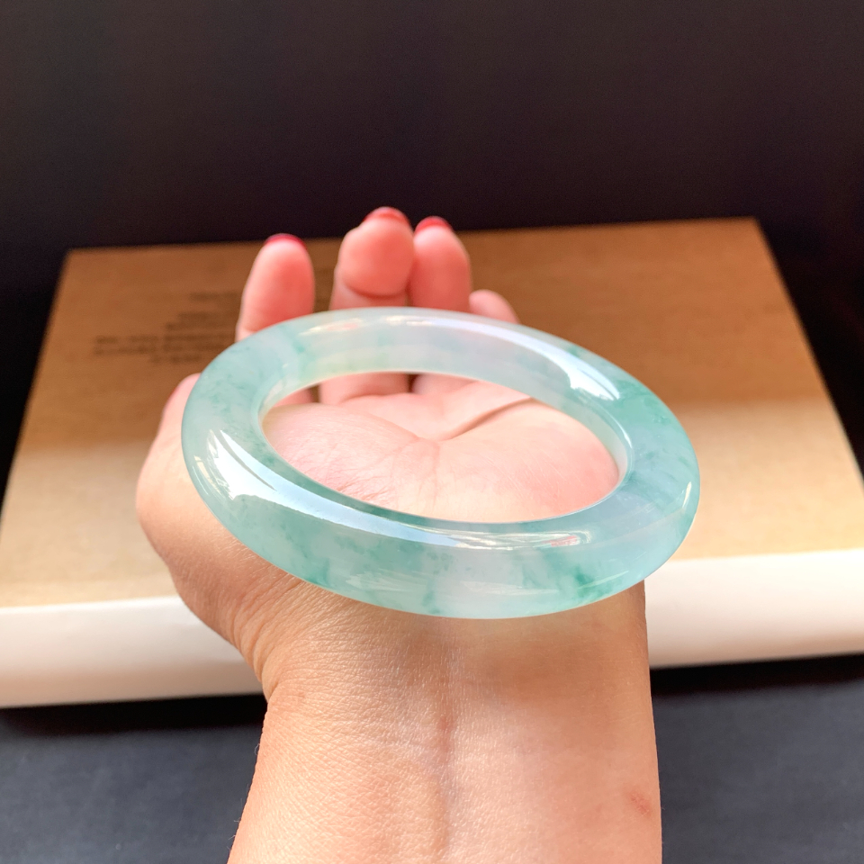 Jade bracelet worn in traditional Asian cultural attire