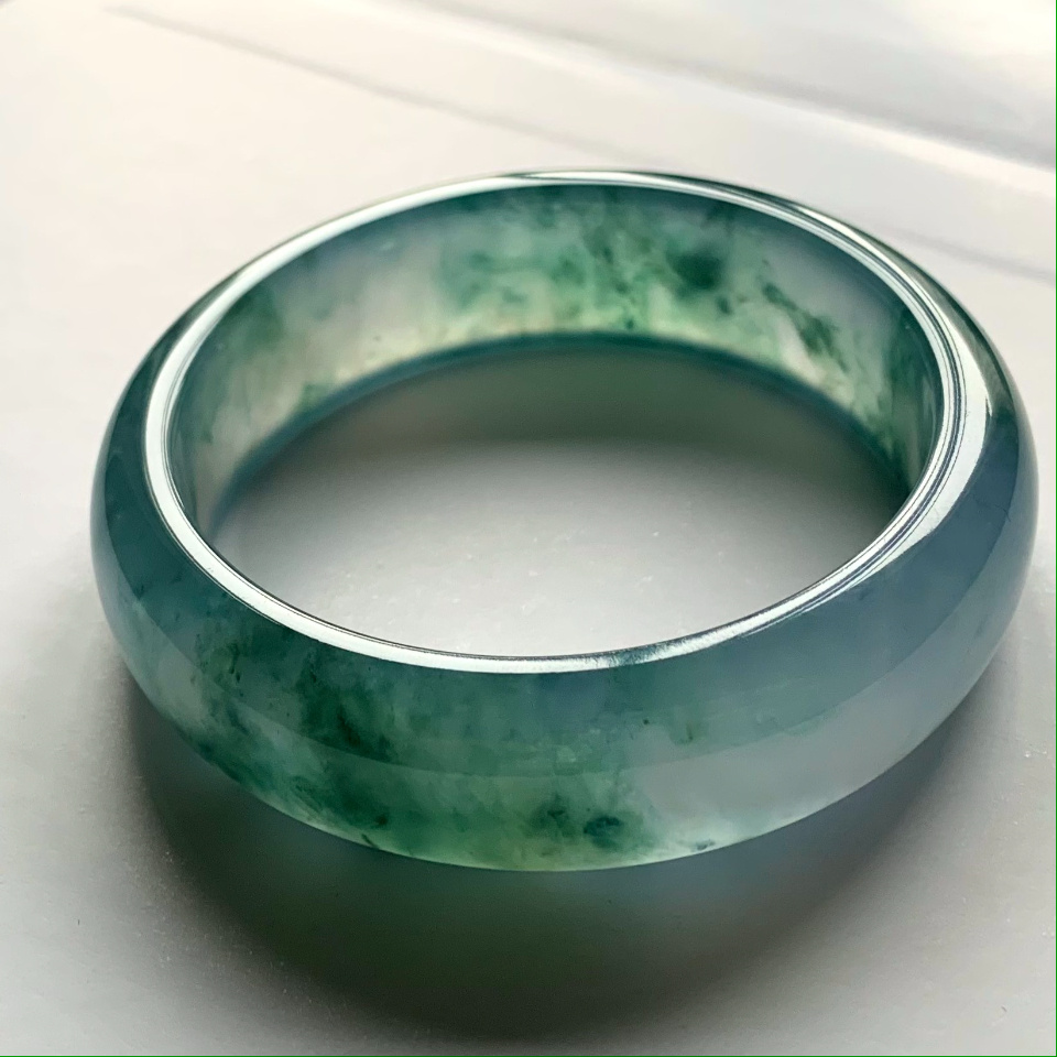 Woman wearing jade bracelet representing cultural heritage