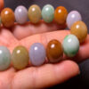 Close-up of 13.2mm tricolor jade beads showing texture and color variation