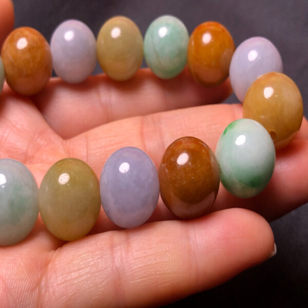 Close-up of 13.2mm tricolor jade beads showing texture and color variation