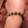 Left side view of 18K gold jade bracelet with colorful jadeite stones