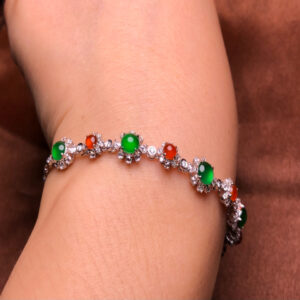 Front view of elegant jade bracelet with gold featuring red and green jadeite stones