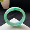 Left angle showing the jade bracelets' rounded edges and thickness