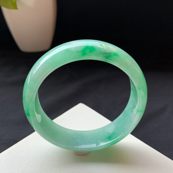 Left angle showing the jade bracelets' rounded edges and thickness