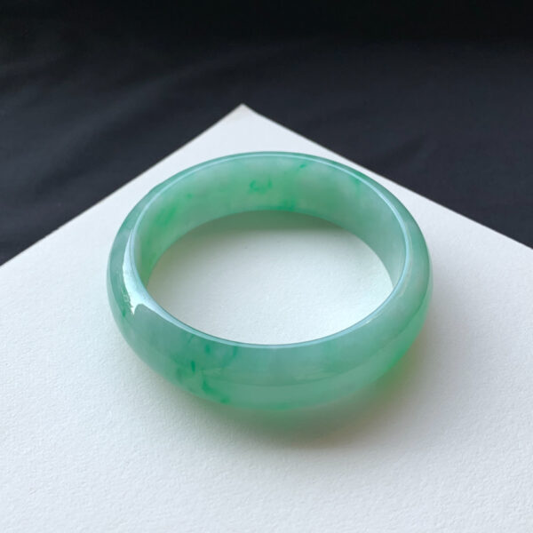 Right angle of real jade bracelets highlighting translucency and color depth