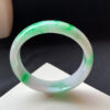 Natural light shining on genuine jade bracelets bright green icy bangle