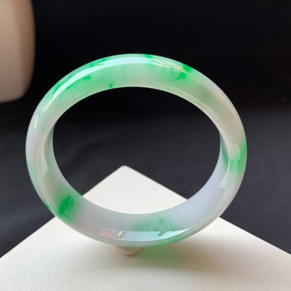 Natural light shining on genuine jade bracelets bright green icy bangle
