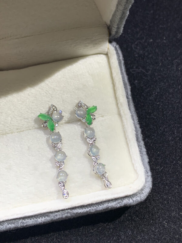 Front view of 18K gold jade earrings for women with smooth oval cabochon design