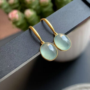 Front view of 18K gold jade earrings featuring smooth oval cabochon jade drops