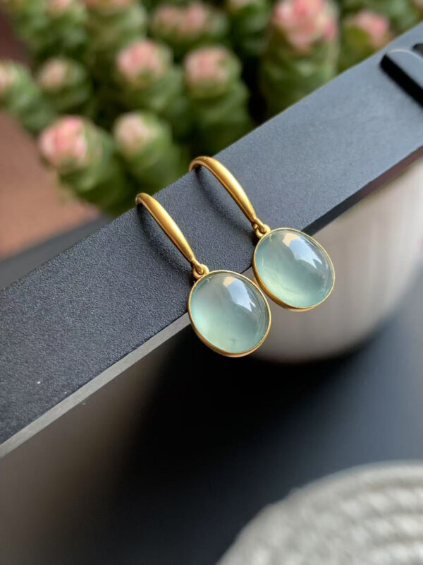 Front view of 18K gold jade earrings featuring smooth oval cabochon jade drops