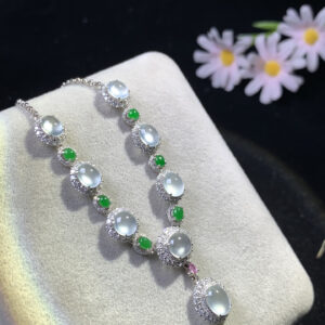 Front view of 18K gold jade necklace featuring white icy and full green jade cabochon pendants