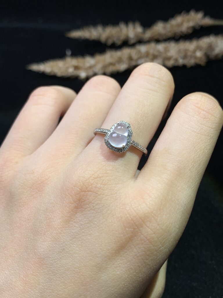 Close-up of jade ring jewelry being gently cleaned with soft cloth