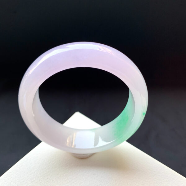 Jade stone bracelet with spring-inspired green flecks, symbolizing renewal and hope.