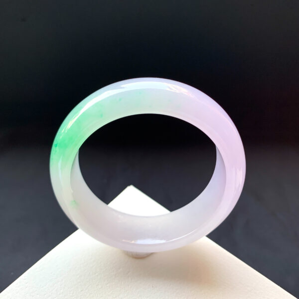 Classic wide-band jade stone bracelet featuring smooth green tones and timeless beauty.