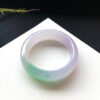 Translucent jade stone bracelet with spring green hues, conveying vitality and good fortune.