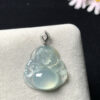 Close-up detail of Buddha carving on icy jadeite pendant with 18K gold border