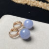Front view of 18K gold lavender jade earrings featuring 13mm ice-purple jade beads