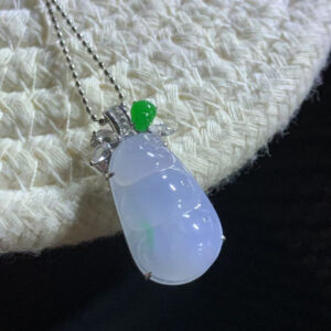 Front view of 18K gold lavender jade pendant featuring icy purple and floating green lucky bean carving