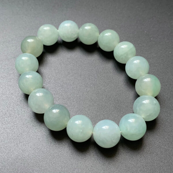 Left side angle of mens jade bracelet with translucent green jade beads