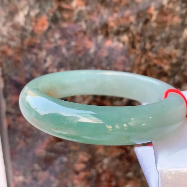 Left side view of real jade bracelet with yellow veins