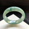 Real jade bracelet worn on wrist in natural light